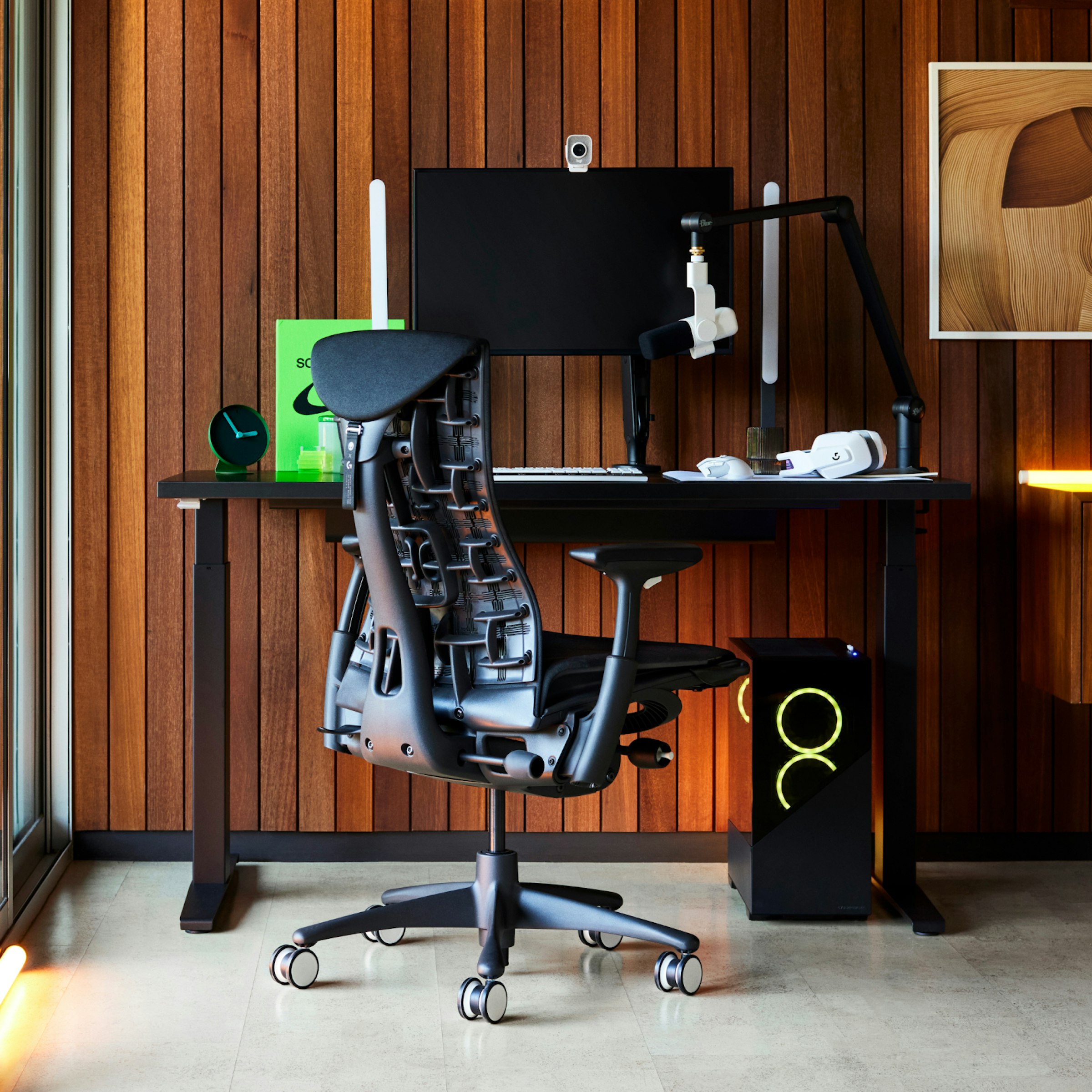 Embody Gaming at a walnut-wall desk with a boom mic